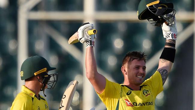 Australia's Ben McDermott (R) celebrates after reaching his century. Picture: Arif ALI / AFP)