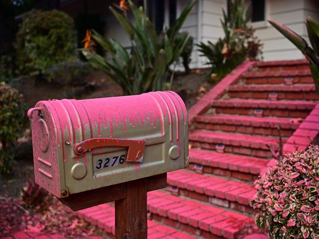 Red flame retardant is seen on the mailbox of a home in the Mandeville Canyon neighbourhood of Los Angeles, as a preventive measure when winds pick up and air crews can’t fly. Picture: AFP