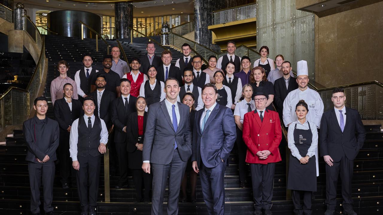 Crown employees alongside outgoing Crown Resorts chief executive Steve McCann (front right), and Blackstone head of real estate Australia Chris Tynan (front left) when the company’s takeover came into effect two weeks ago.