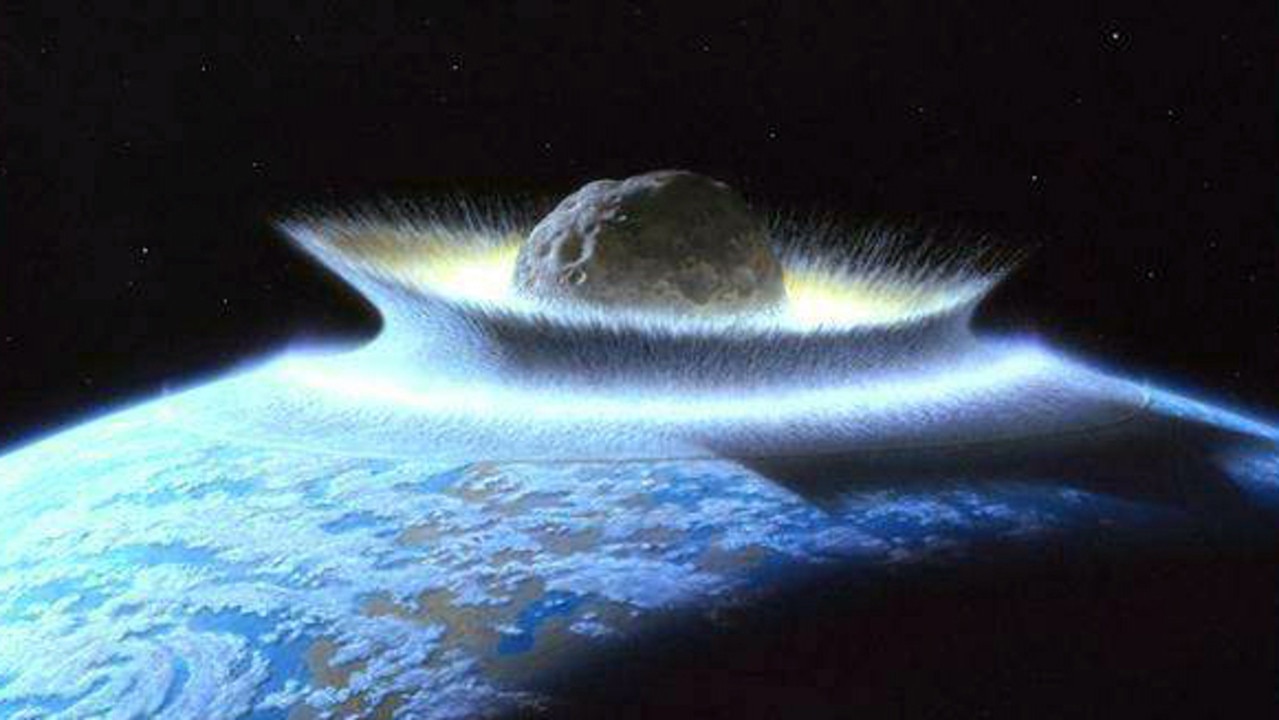 When an asteroid strikes, it creates a crater with an uplifted core, similar to how a drop of water splashes upward when you drop a pebble in a pool. Picture: NASA / Don Davis.