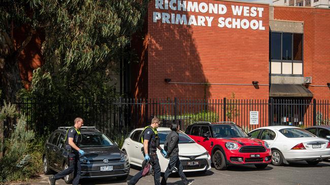 A man was led away in handcuffs in the school’s carpark. Picture: Jason Edwards