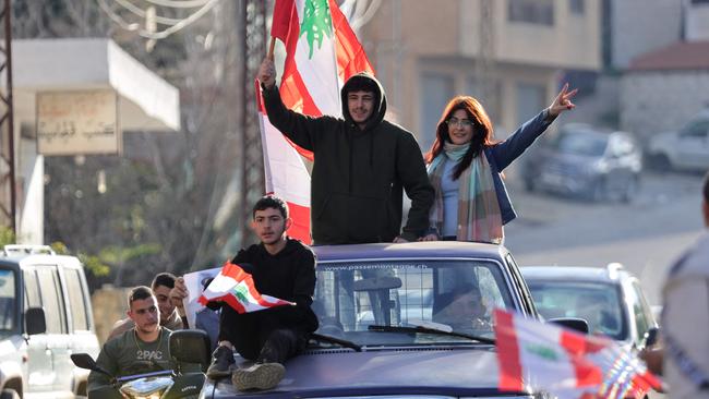 People lift national flags as they celebrate the election of a new president for Lebanon. Picture: AFP.