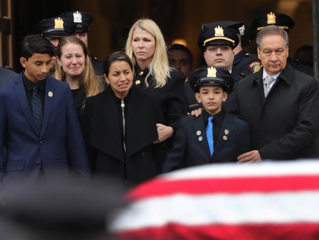 Family members watch as the coffin of New Jersey Detective Joseph Seals leaves the church after his funeral. Picture: AFP