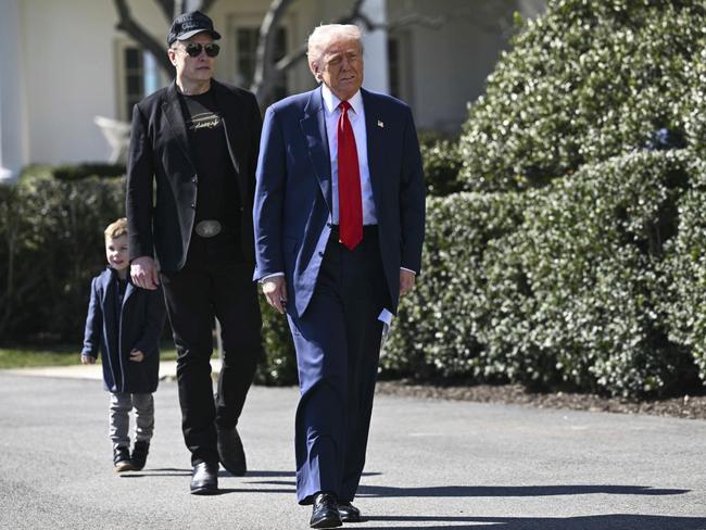 President Donald Trump, with Tesla CEO Elon Musk, and his son arrive on the South Lawn of the White House in Washington. Picture: AP