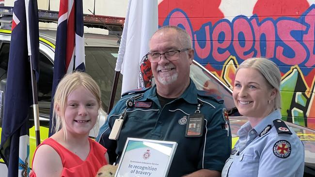 Aubree Tidyman with assistant commissioner Peta Thompson and paramedic Richard Taylor at an awards ceremony on Thursday in Toowoomba. Picture: Marcus de Blonk Smith