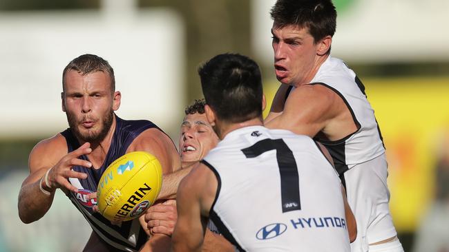 Brett Bewley battles with three Blues for possession during the Marsh Series.