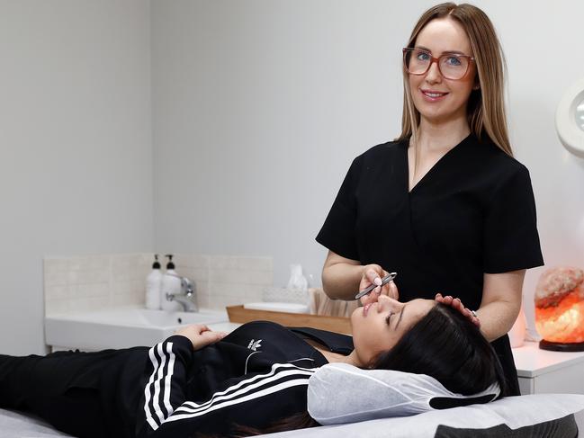 Sydney beautician Dominique Cavallaro with client Renee Fisher at her salon Norwest Holistic Skin and Beauty. Picture: Sam Ruttyn