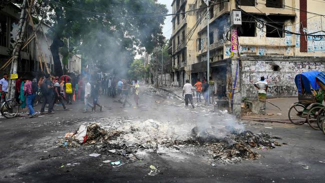 Smoke billows near burnt Awami League office in Dhaka. Picture: AFP