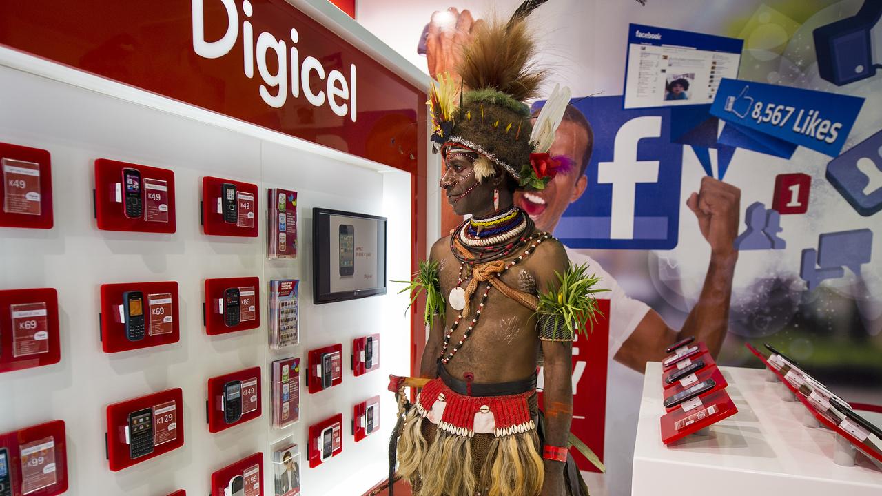 A Huli man in traditional ceremonial dress at a mobile phone shop in PNG’s capital of Port Moresby.