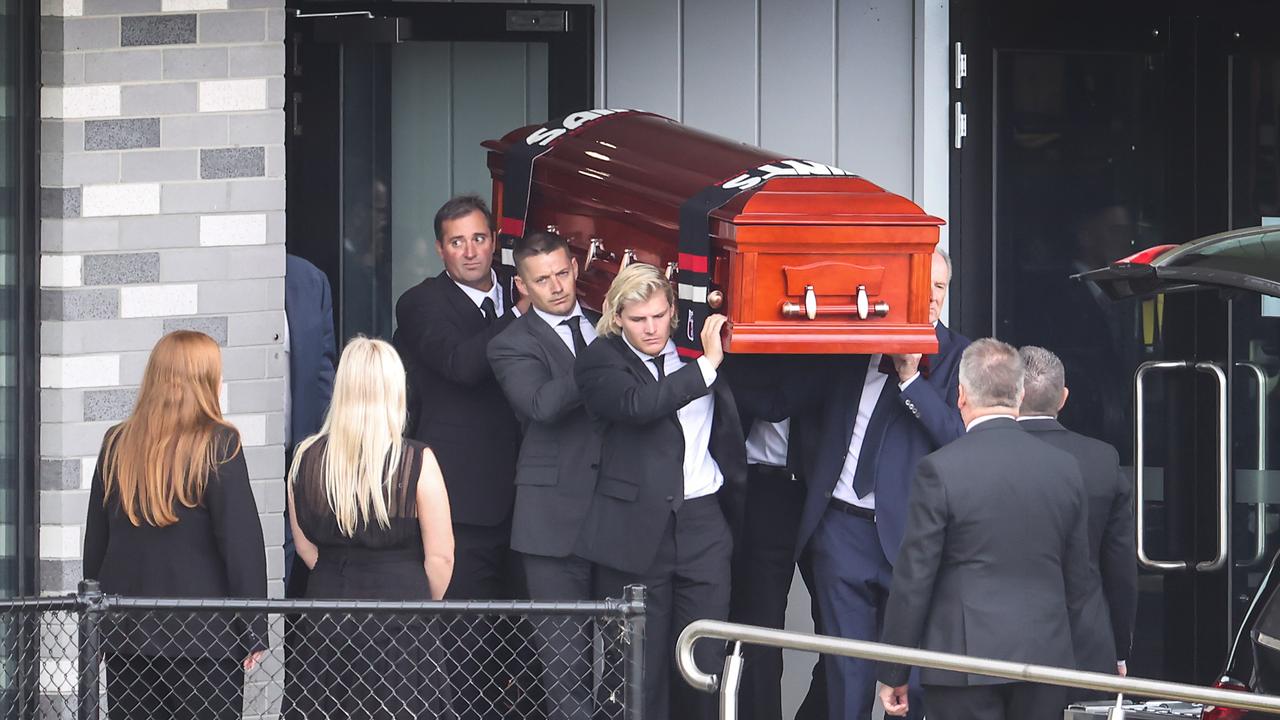The coffin of Shane Warne is carried out by his son Jackson. Picture: David Caird