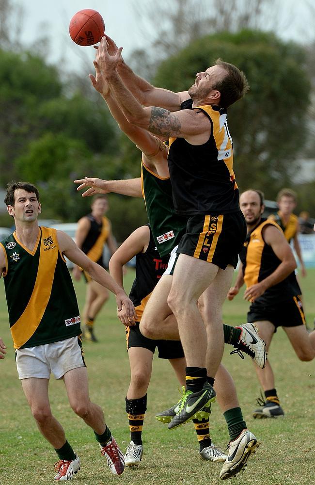 HIGH ACTION: Aldinga Sharks’ Brad Hooper goes for a mark against Marion at Shark Park, Aldinga. Picture: Mark Brake. 