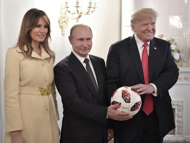 U.S. First Lady Melania Trump, left, Russian President Vladimir Putin, center, and U.S. President Donald Trump, pose with a soccer ball after a press conference following their meeting at the Presidential Palace in Helsinki, Finland, Monday, July 16, 2018. (Alexei Nikolsky, Sputnik, Kremlin Pool Photo via AP)