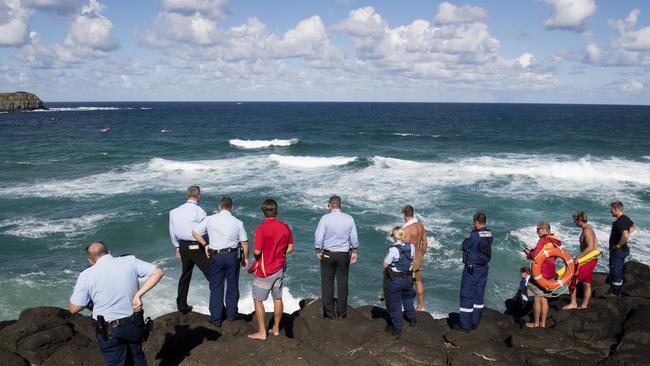 Police and Surf Life Savers search for a drowning victim from the rocks at the Fingal Head Lighthouse, Fingal Head.