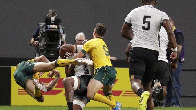 Australia’s Reece Hodge (right) flies as he is pushed away by Fiji’s Peceli Yato. Hodge has been cited over the contact. Picture: AP