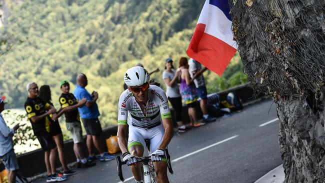 Scenic views: A spectator waves a French flag as France's Warren Barguil rides a counter attack during the tenth stage of the 105th edition of the Tour de France. Picture: AFP PHOTO/Jeff Pachoud