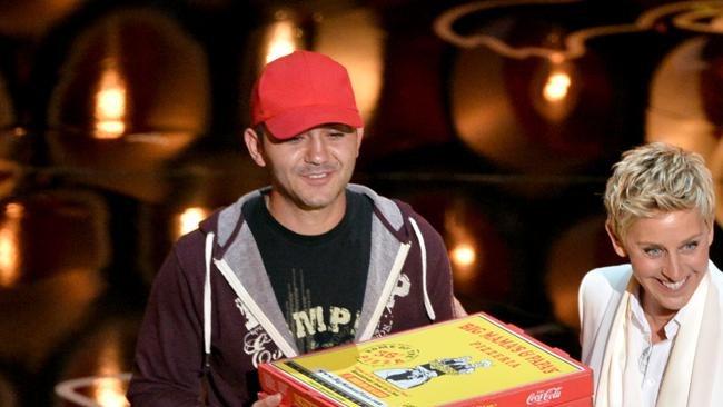 Tip please ... Oscars host Ellen DeGeneres (R) with pizza delivery man Edgar onstage during the Oscars telecast.