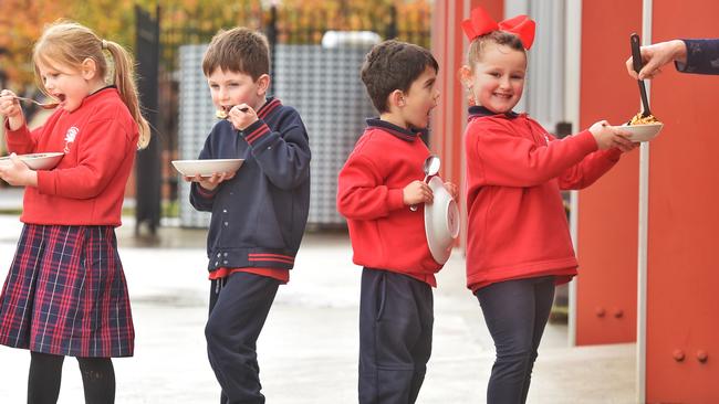 (L-R) Lily, Tobias, Kobe and MacKenzie bring a bowl to the canteen for some hot pasta. Picture: Tony Gough
