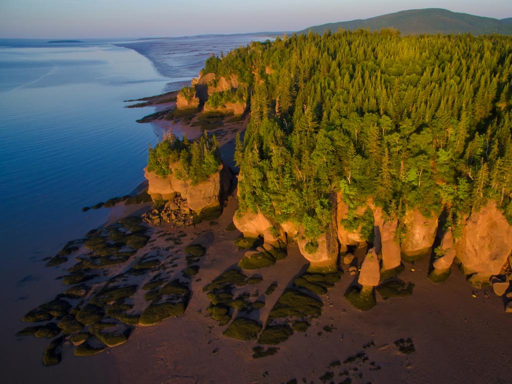 <span>8/20</span><h2>Hopewell Rocks, New Brunswick</h2><p> Time and tide have carved the majestic <a href="https://www.tourismnewbrunswick.ca/" target="_blank">Hopewell Rocks</a> into these bizarre sandstone formations, topped with trees. No wonder they’re also known as Flowerpot Rocks. Situated on the upper reaches of the Bay of Fundy, famous for its extreme tidal range, you can walk around these unique formations at low tide.</p>