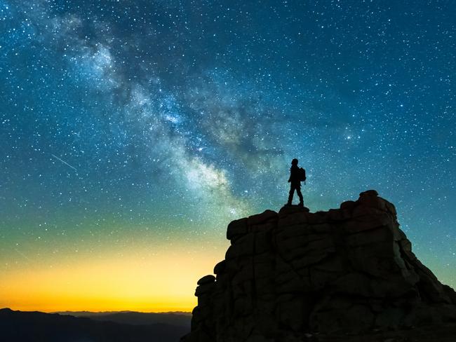 Landscape with Milky Way and silhouette of a hiker man