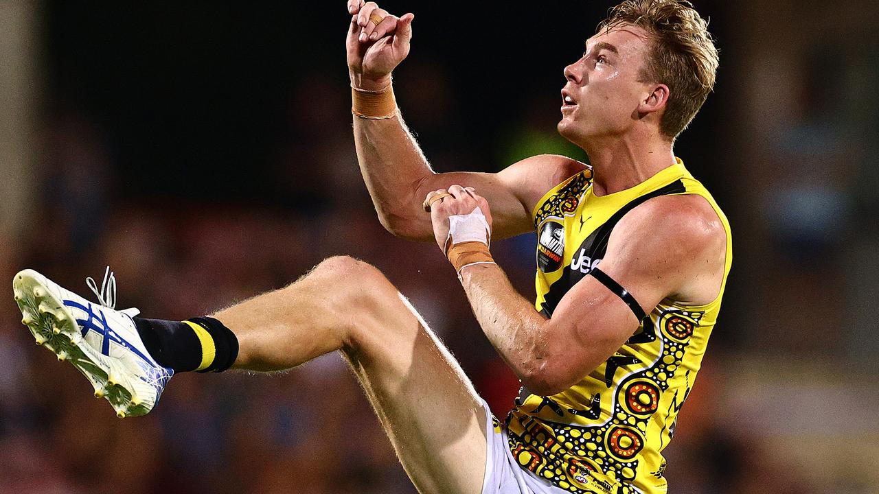 Tom Lynch kicks the ball during the clash with Essendon.