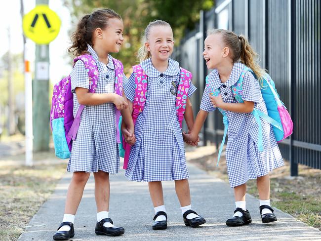 Triplets Mackenna, Madisyn and Mariyah King get ready for their first day of kindergarten. Picture: Tim Hunter