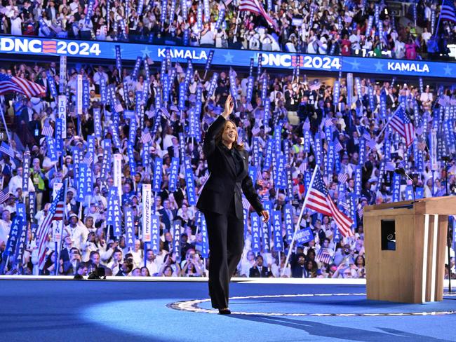 TOPSHOT - US Vice President and 2024 Democratic presidential candidate Kamala Harris waves as she arrives onstage to speak on the fourth and last day of the Democratic National Convention (DNC) at the United Center in Chicago, Illinois, on August 22, 2024. Vice President Kamala Harris formally accepted the partyâs nomination for president today at the DNC which ran from August 19-22 in Chicago. (Photo by Robyn Beck / AFP)