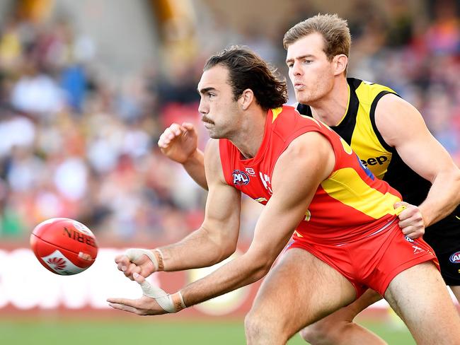 Brayden Crossley of the Suns handballs during the round 21 AFL match between the Gold Coast Suns and the Richmond Tigers at Metricon Stadium on August 11, 2018 in Gold Coast, Australia. (Photo by Bradley Kanaris/Getty Images)