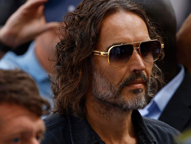 British actor and comedian Russell Brand arrives at Westminster Magistrates Court in London on May 2, 2025. Brand has been charged with rape and a number of other sexual offences alleged to have taken place between 1999 and 2005 involving four women. (Photo by BENJAMIN CREMEL / AFP)