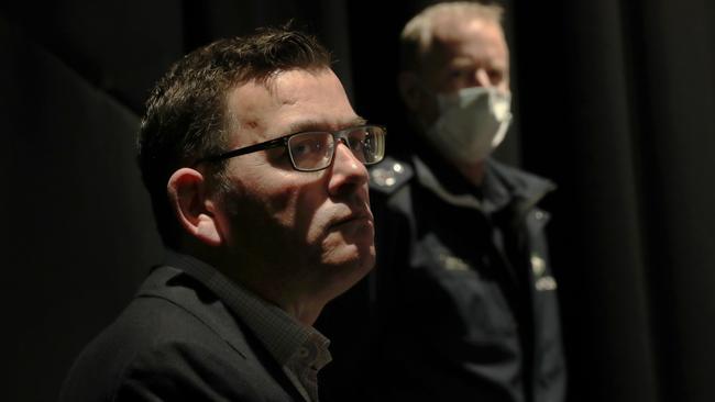 Victoria Police Deputy Commissioner Rick Nugent watches on as Premier Daniel Andrews talks about the COVID crisis confronting the state. Picture: NCA NewsWire / David Crosling