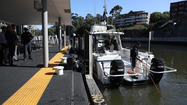 Queensland and NSW police watch as police divers enter the river. Picture: John Grainger