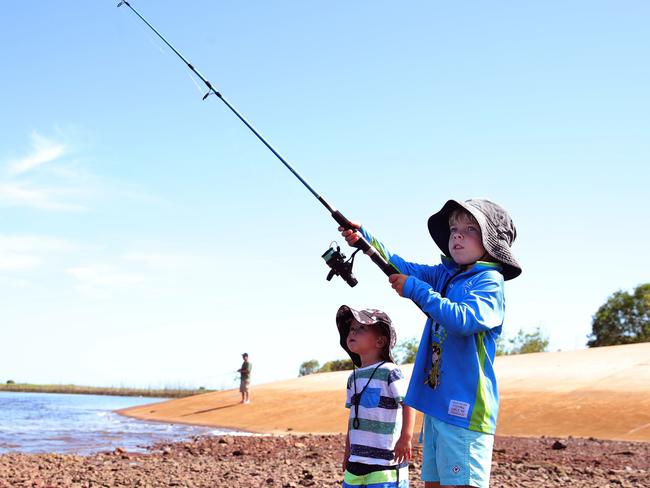 Siblings Reuben Aitken,2, and watches as his brother Spencer Aitken,4, casts a line in hope of a Barra at Shady Camp Barrage on Sunday while the boys are visiting the NT with their parents from Queensland.Picture: Justin Kennedy