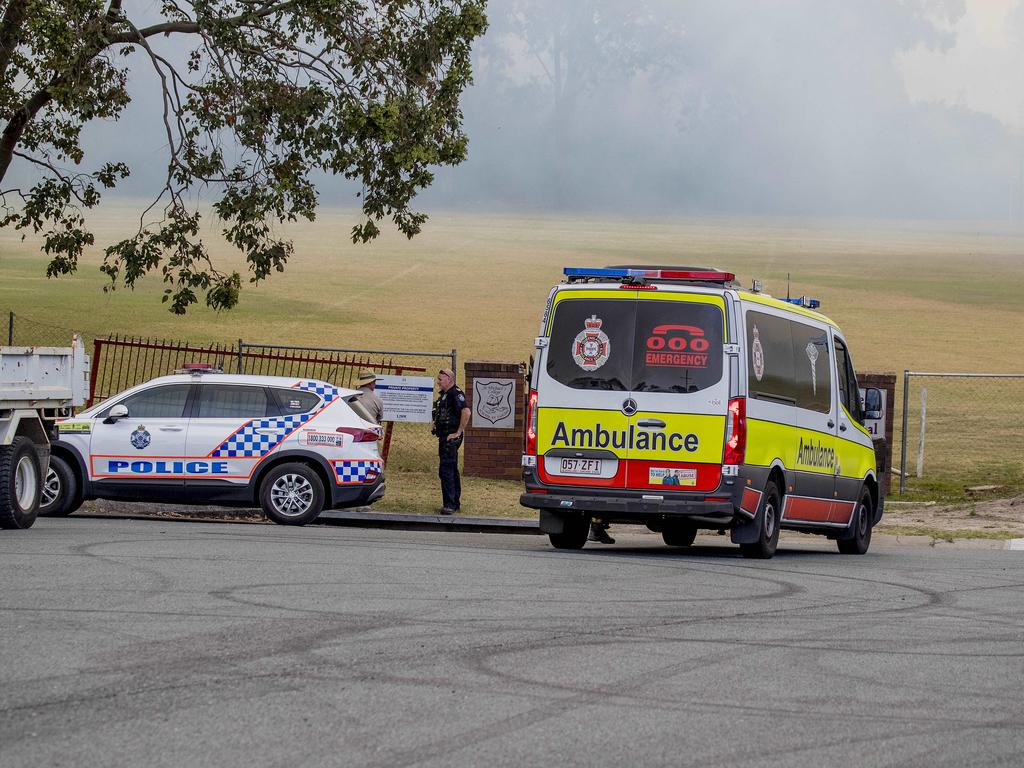 Smoke haze covers the Gold Coast Skyline from a grass fire at Carrara. Emergency services at St Michael's Collage, Merrimac. Picture: Jerad Williams