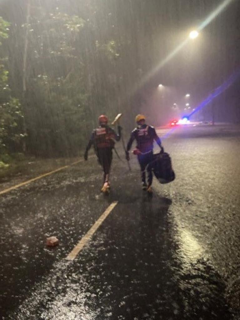 A father, his pregnant wife and three children, all believed to be aged under six, were unable to leave the car due to the floodwaters lapping at their doors. Picture: FRNSW