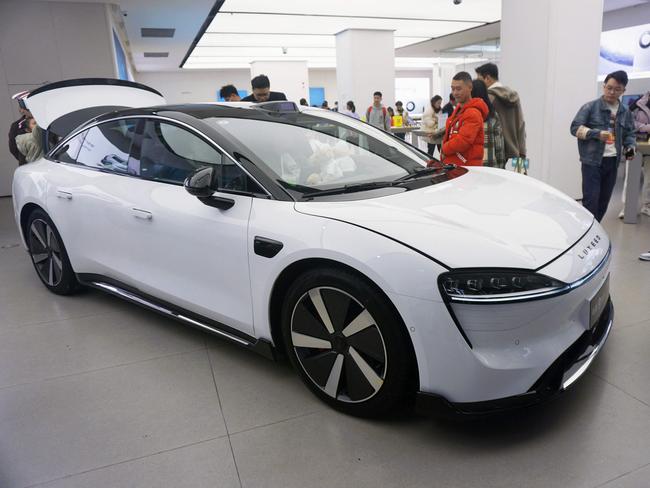 Visitors look at the Luxeed S7, the first sedan produced by Chinese tech giant Huawei, at a Huawei showroom in Hangzhou, in Chinaâs eastern Zhejiang province on December 12, 2023. (Photo by AFP) / China OUT