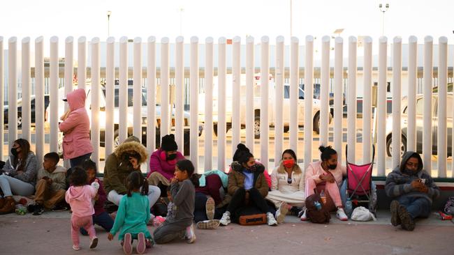 Asylum seekers wait outside the El Chaparral border crossing port as they wait to cross into the United States on the Mexican border. Picture: AFP