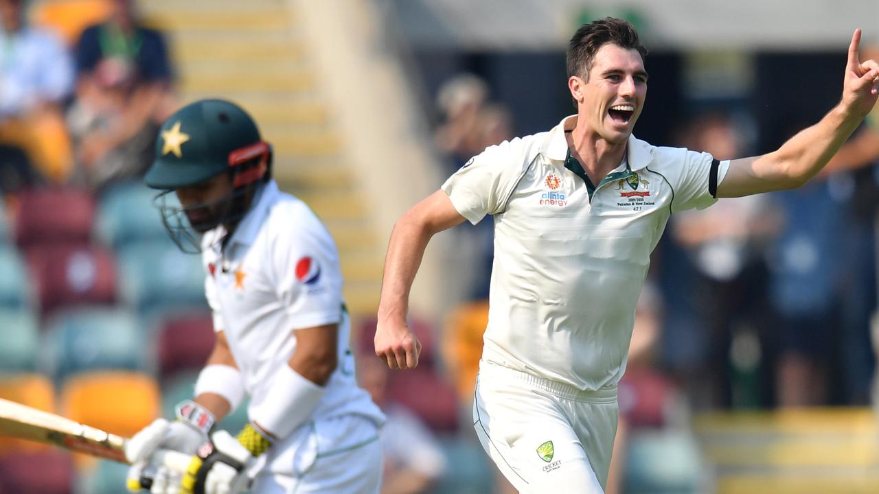 Pat Cummins of Australia (right) celebrates the wicket of Mohammad Rizwan.