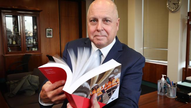 Victorian Treasurer Tim Pallas in his office with the 2023-2024 State Budget report. Picture: David Caird