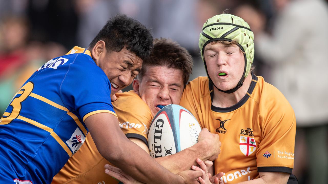 Country’s Caleb Mcrea is tackled by Phoenix Godinet in the under 16s. Picture: Julian Andrews