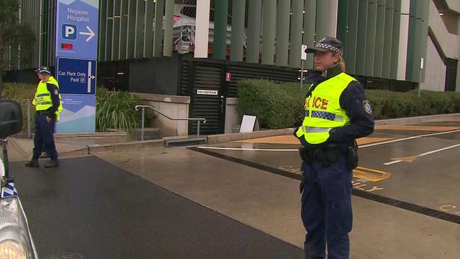 Police stand guard near the scene of the shooting.