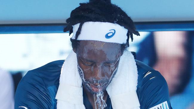 Gael Monfils tries to cool off with some water during his match against Novak Djokovic. Picture: Michael Klein