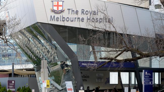 People queue to enter the Royal Melbourne Hospital as it deals with a large COVID cluster. Picture: NCA NewsWire / Andrew Henshaw