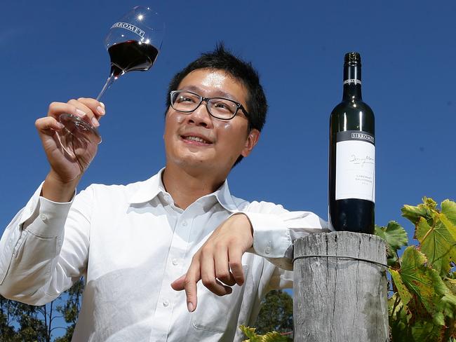 Sirromet's Eric Yu with a glass of red wine in the vineyard.  The Chinese are behind a massive surge in wine exports. Pic Peter Wallis