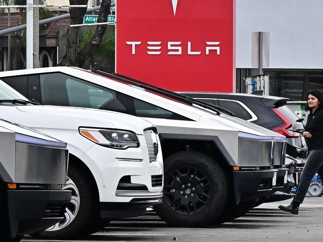 Vehicles on the lot at a Tesla dealership in Alhambra, California on March 11, 2025. Tesla has taken a massive hit over the past few months with people protesting against Elon Musk and sales slumping overseas as stocks continue to drop, wiping out billions in market value. President Donald Trump responded on March 11, 2025 to plummeting Tesla share prices by briefly turning the White House into a showroom, announcing he was buying one of the electric cars manufactured by close advisor Elon Musk, and threatening anti-Tesla protesters with "hell." (Photo by Frederic J. BROWN / AFP)