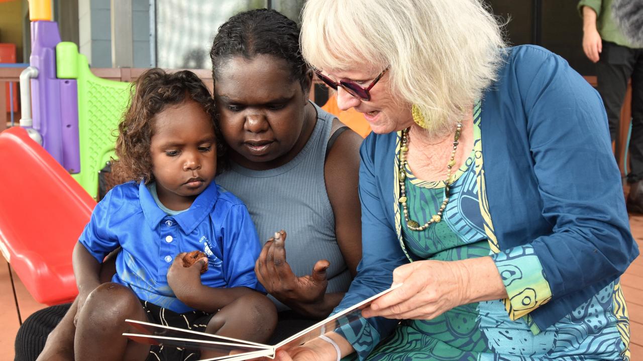 Gunbalanya School's first Families as First Teachers Educator Nuala Scannell works through conversational reading exercises with a parent and child as part of the FAFT program. Picture: Sierra Haigh