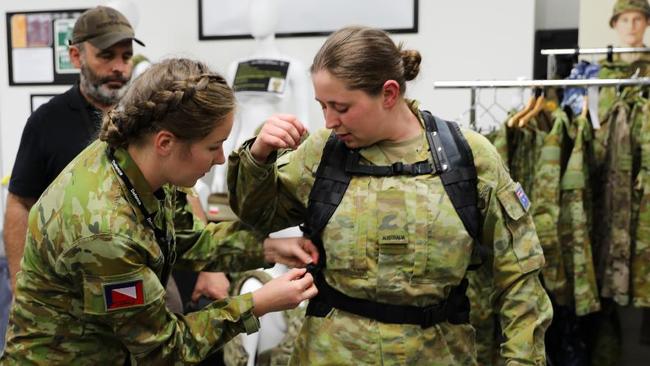 Lance Corporal Rebecca Baxter from the 4th/19th Prince of Wales Light Horse Regiment adjusts the prototype female heavy-webbing harness and belt on Private Jessica Russell from the 8th/7th Battalion, Royal Victoria Regiment. Picture: Captain Kristen Cleland