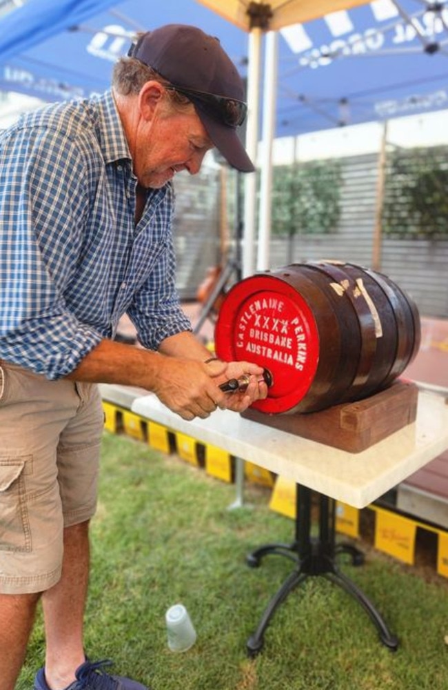 Tim Gleeson spikes a keg of XXXX the traditional way at Moo and Brew Festival