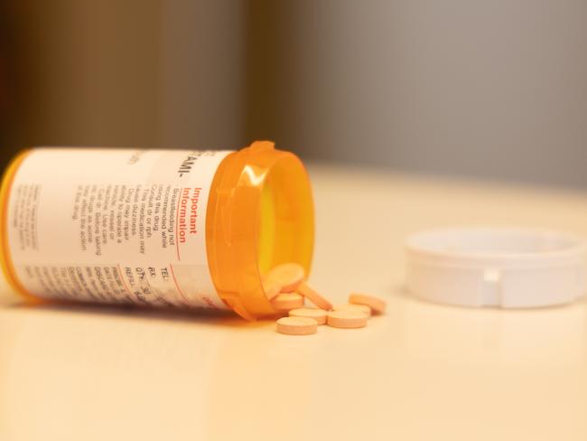 This is a photo of some ADHD medication on a counter. The pills are coming out of the bottle.