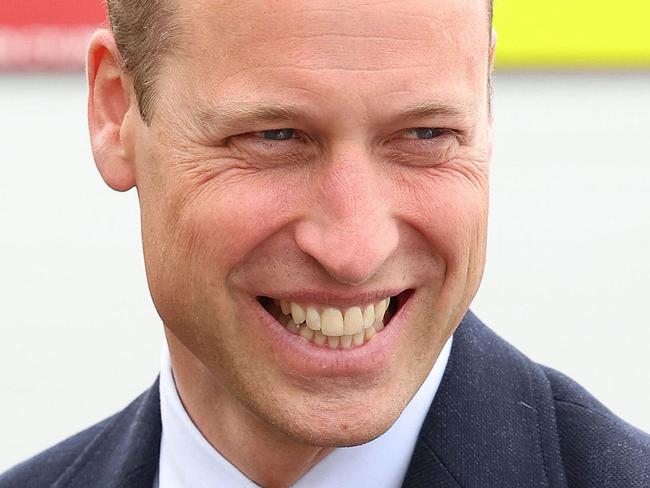 Britain's Prince William, Prince of Wales, laughs as he speaks to base personnel after a simulated fire response exercise during a visit to RAF Valley in Holyhead in Anglesey, North Wales, on July 9, 2024. (Photo by Chris Jackson / POOL / AFP)