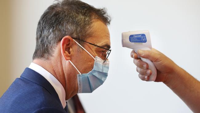 Premier Steven Marshall has his temperature checked at a press conference at SA mask maker Detmold on Monday. Picture: Tait Schmaal