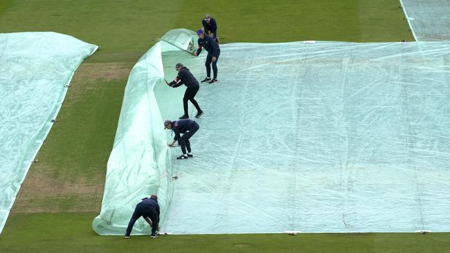 Cover up ... ground staff have been involved in as much action at Headingley today as the players. Picture: AP